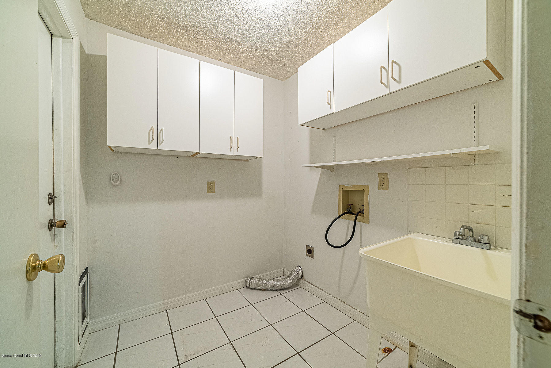 449 Lisa Road Northeast Palm Bay, FL 32907 - Photo 22 of 29 Laundry Room w/ Sink and Cabinetry