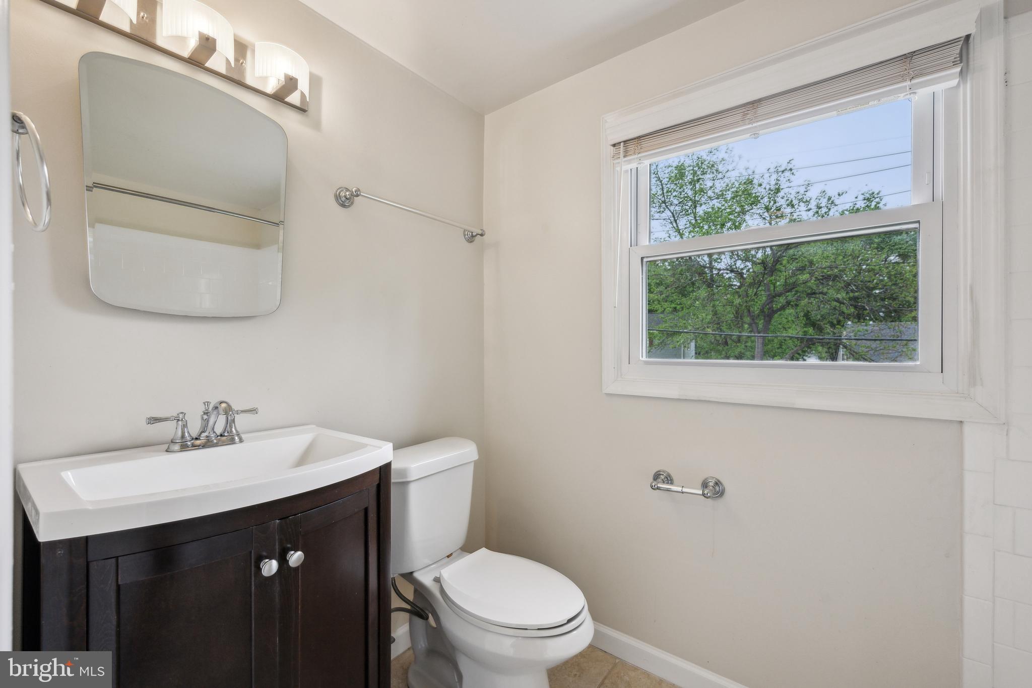 12430 Shadow Lane Bowie, MD 20715 - Photo 19 of 24 a bathroom with a sink vanity mirror and toilet