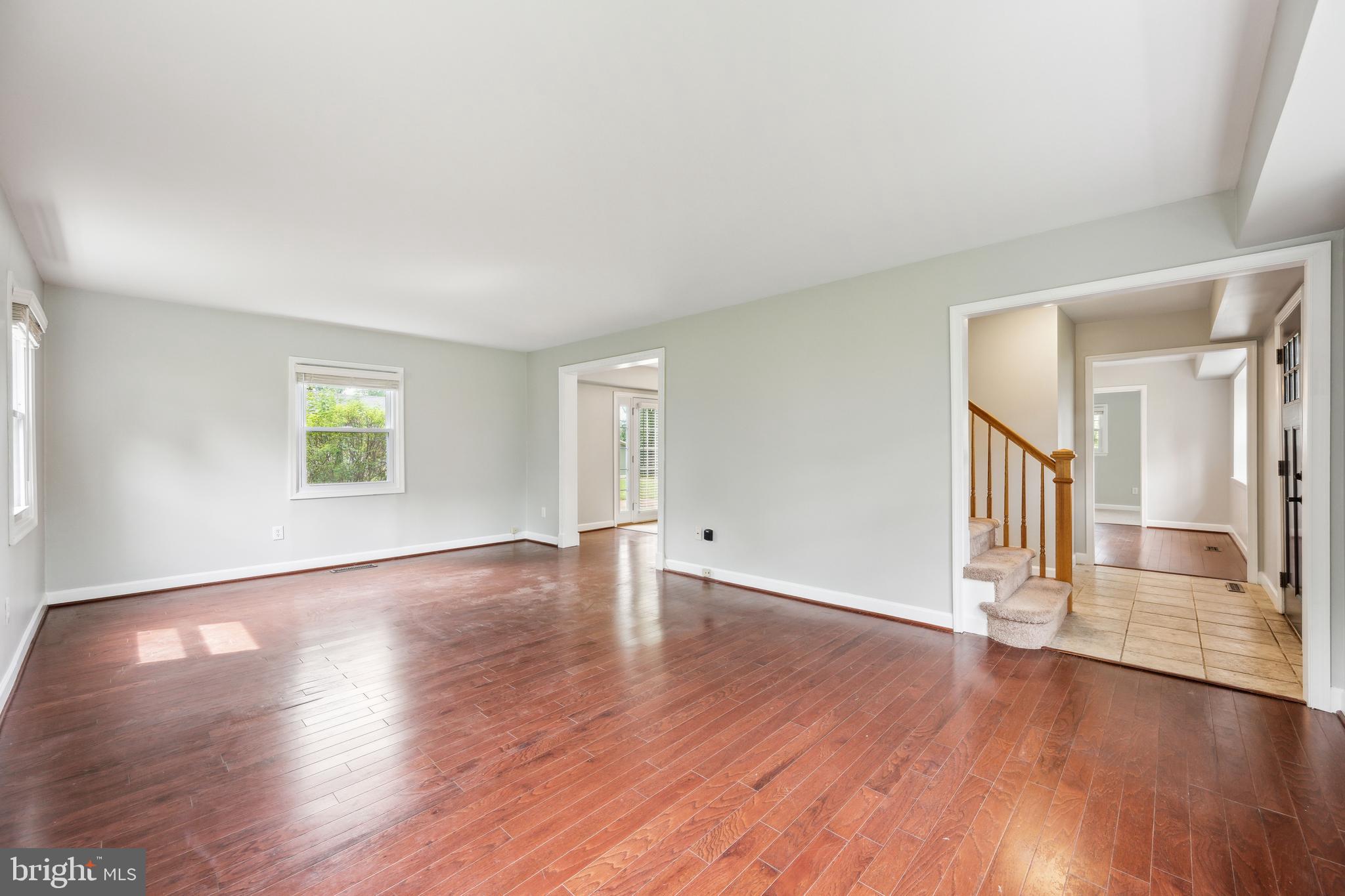12430 Shadow Lane Bowie, MD 20715 - Photo 4 of 24 an empty room with wooden floor and windows