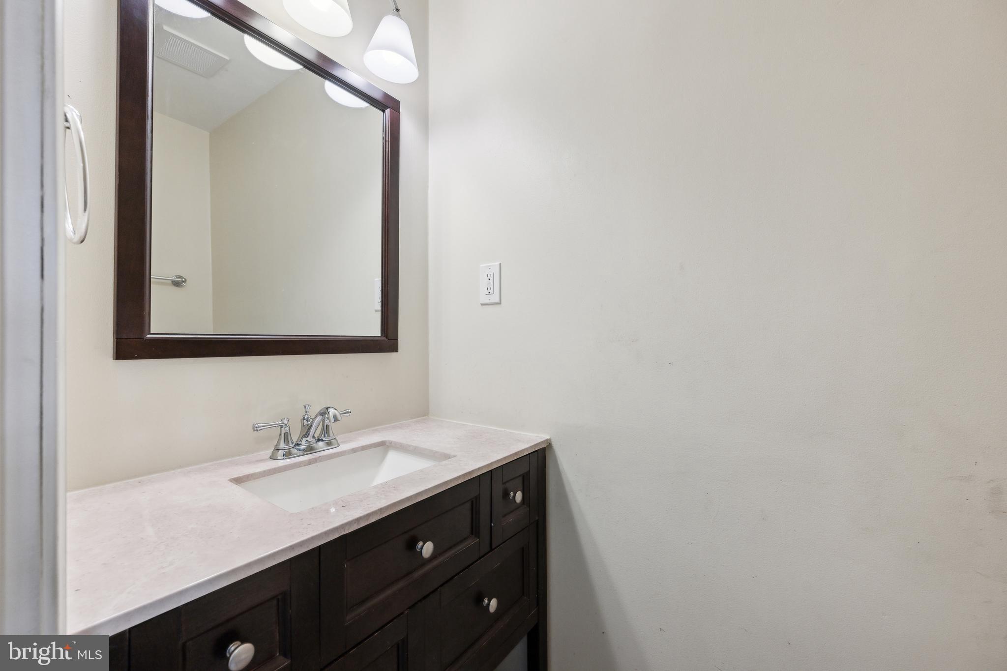 12430 Shadow Lane Bowie, MD 20715 - Photo 9 of 24 a bathroom with a sink vanity and a mirror
