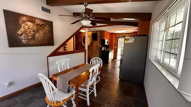 a dining room with furniture and window