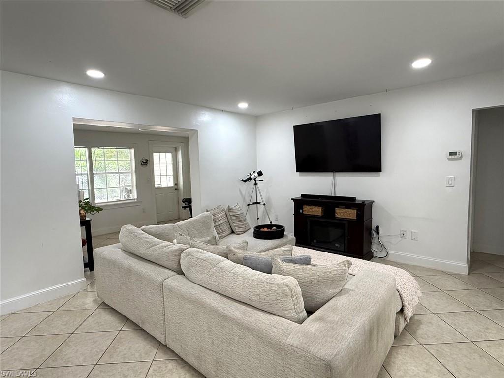 1964 42nd Street Southwest Naples, FL 34116 - Photo 8 of 25 a living room with furniture and a flat screen tv