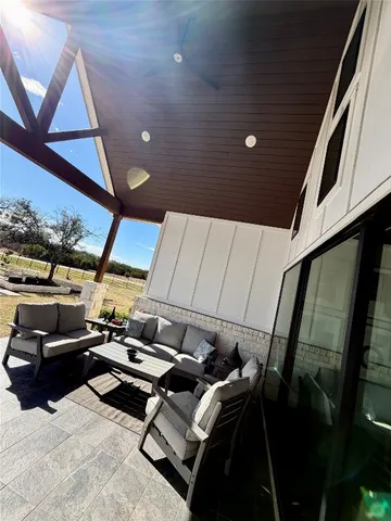a view of gym equipment and sitting area