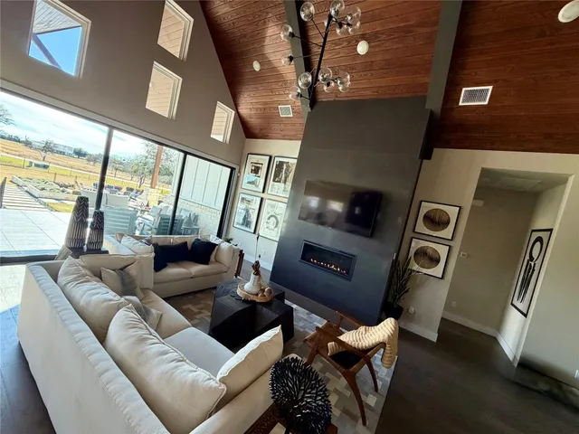 a living room with furniture and a floor to ceiling window