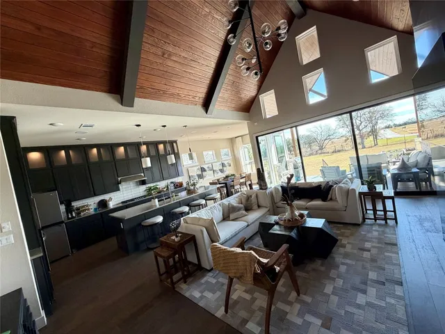 a living room with patio furniture and a large window