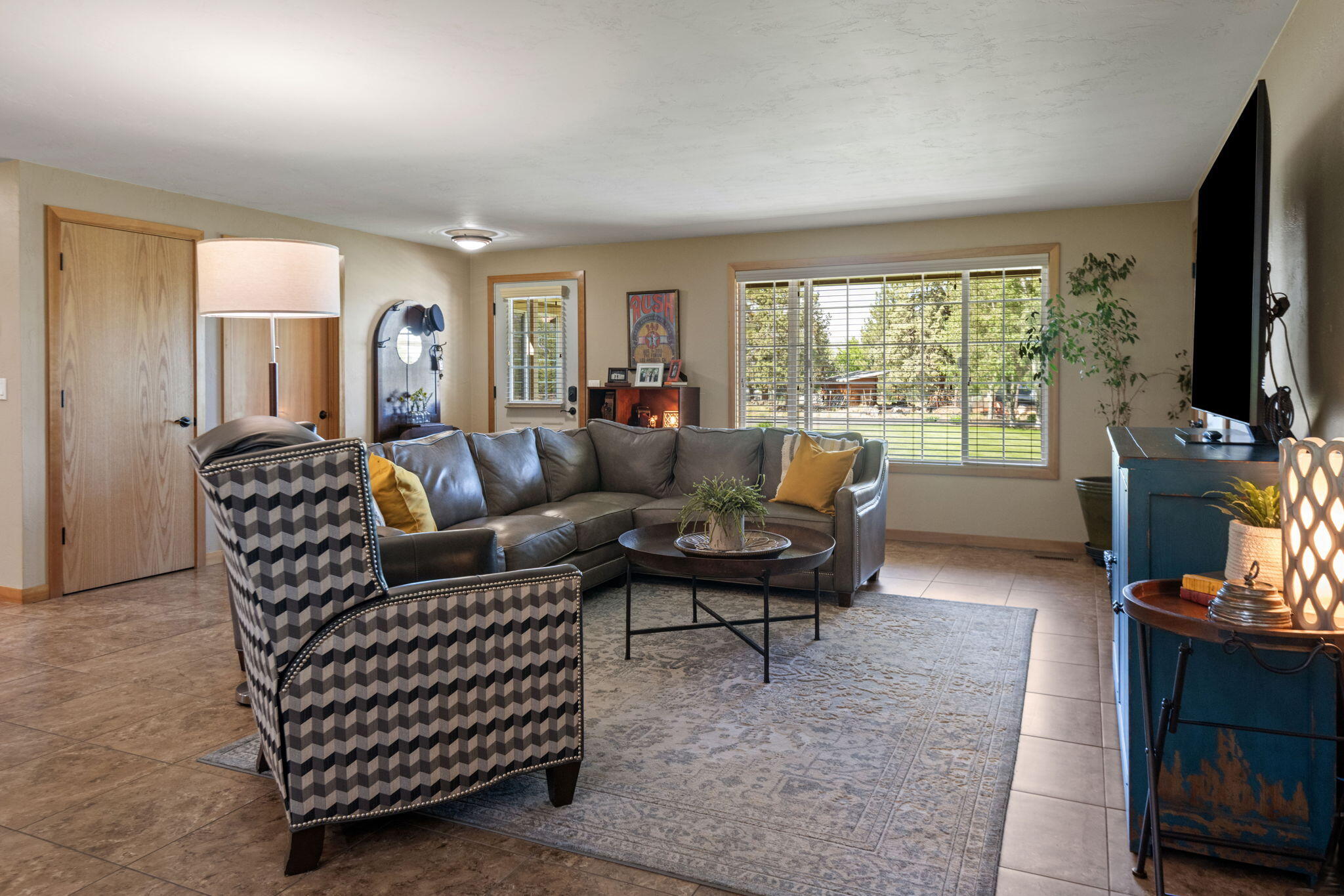 22539 Martee Lane Bend, OR 97701 - Photo 4 of 54 a living room with furniture a flat screen tv and a fireplace