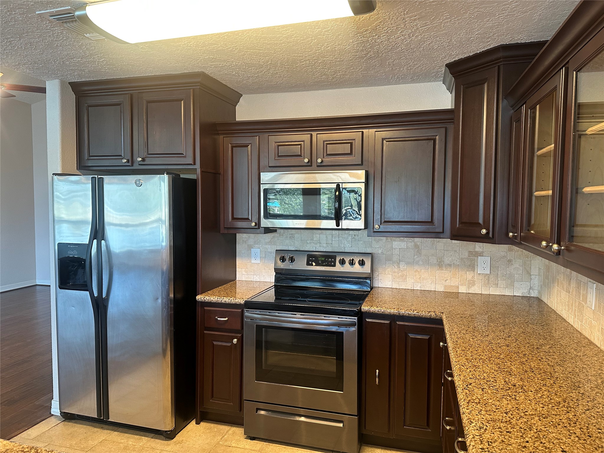 20527 Rio Villa Drive Houston, TX 77049 - Photo 12 of 18 a kitchen with granite countertop a refrigerator and a stove