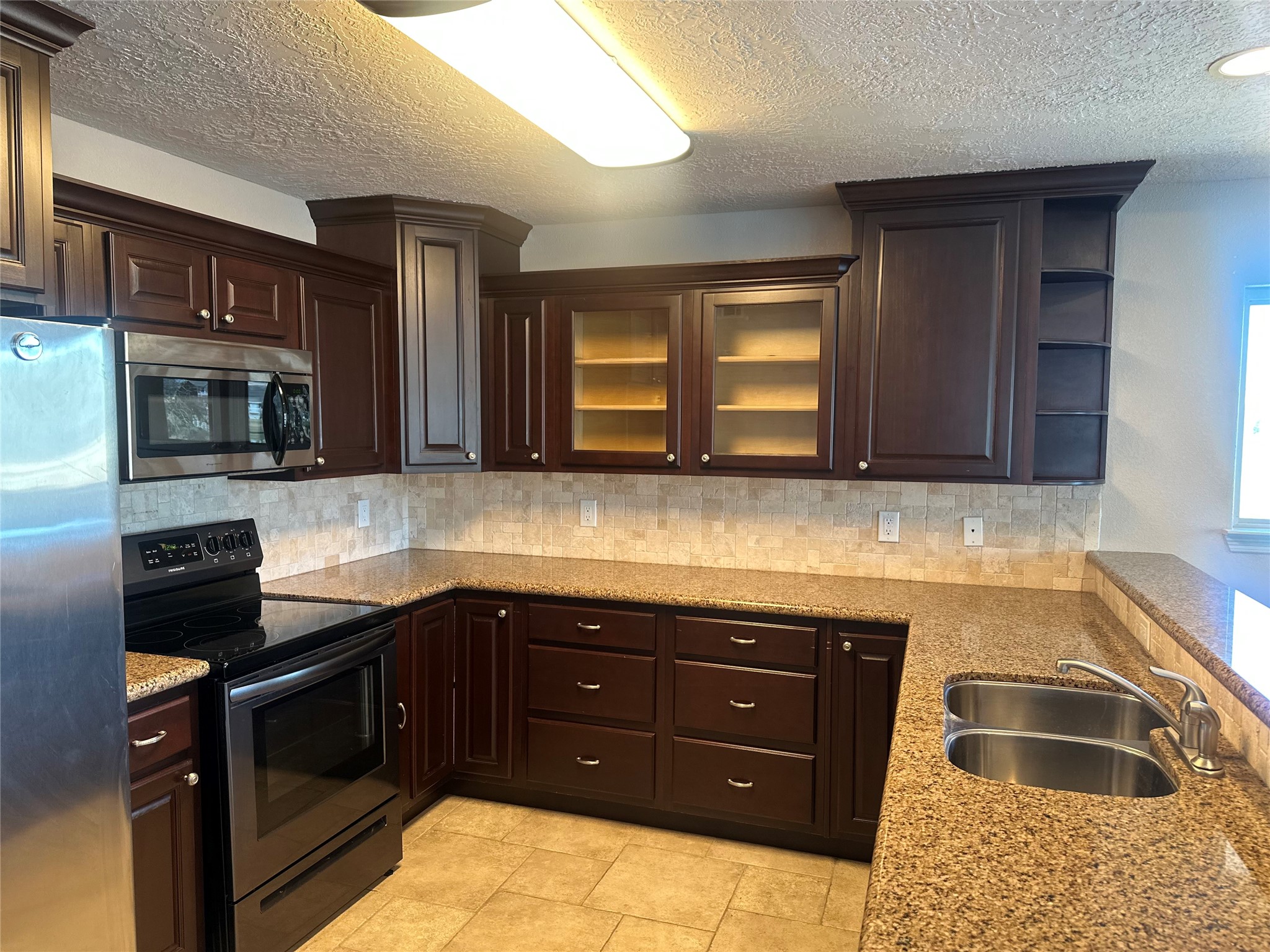 20527 Rio Villa Drive Houston, TX 77049 - Photo 13 of 18 a kitchen with granite countertop a sink and cabinets
