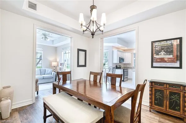 a view of a dining room with furniture wooden floor and a chandelier
