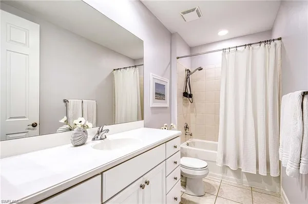 a bathroom with a double vanity sink toilet and shower