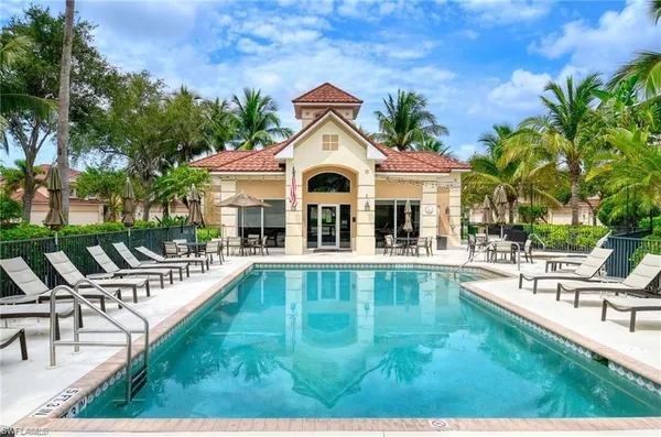 a view of a house with swimming pool and sitting area