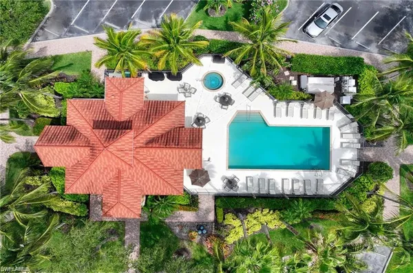 a aerial view of a house with a garden and lake view