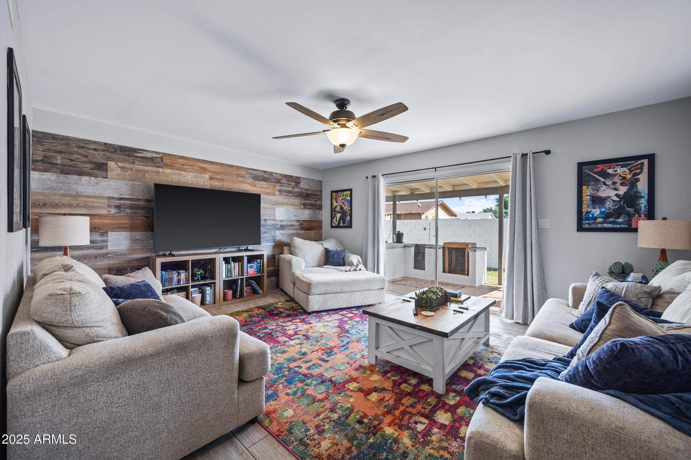 17827 North 9th Avenue Phoenix, AZ 85023 - Photo 6 of 29 a living room with furniture a ceiling fan and a flat screen tv