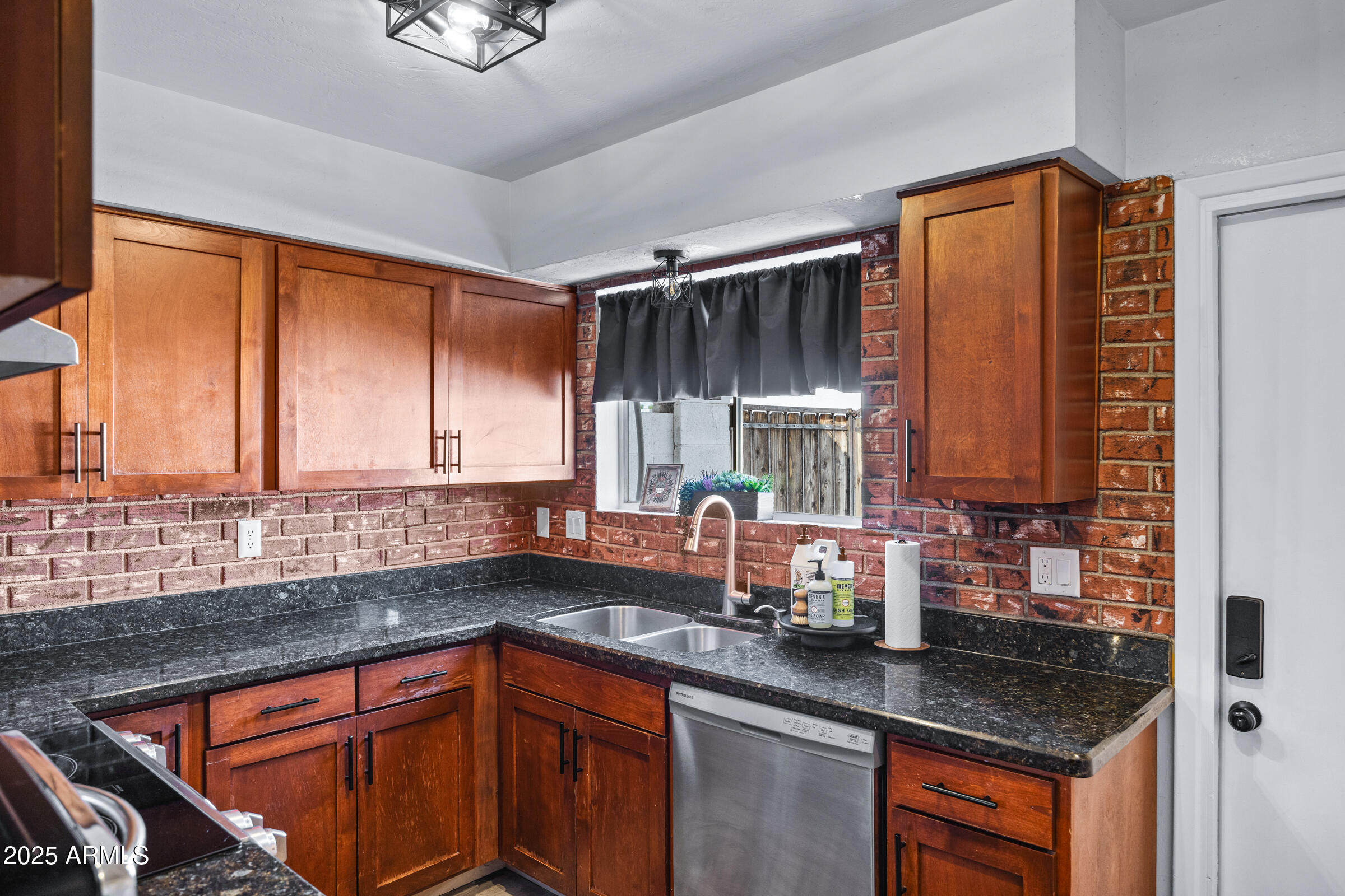 17827 North 9th Avenue Phoenix, AZ 85023 - Photo 10 of 29 a kitchen with stainless steel appliances granite countertop a sink a counter space and a window