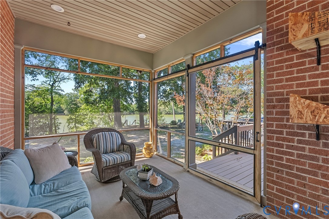 447 Tranquility Road Reedville, VA 22539 - Photo 62 of 82 Screened porch with brick wall, wood-finish ceilin