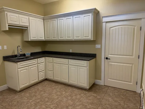a kitchen with white cabinets