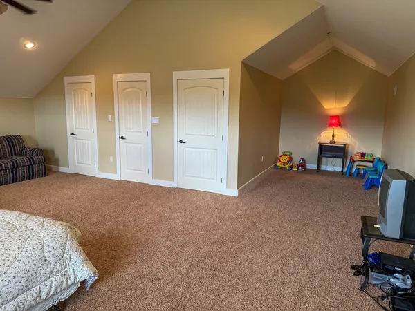 a bedroom with bed and a furniture