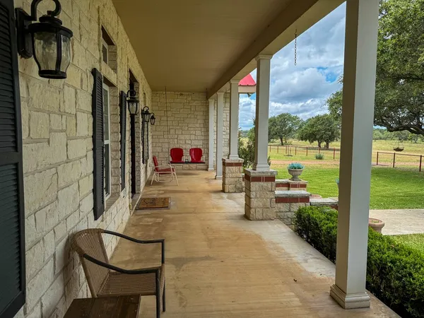 a building outdoor space with patio furniture and potted plants