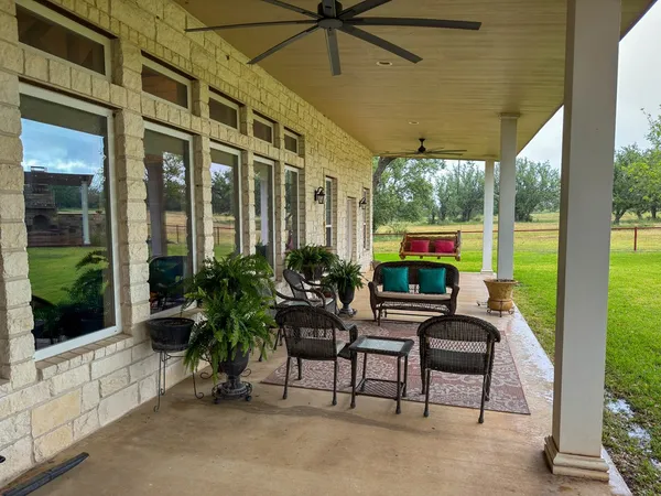 a living room with furniture a rug and a wall painting
