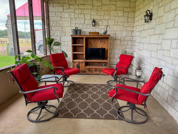 a living room with furniture and a floor to ceiling window