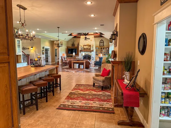 a living room with lots of furniture and a chandelier