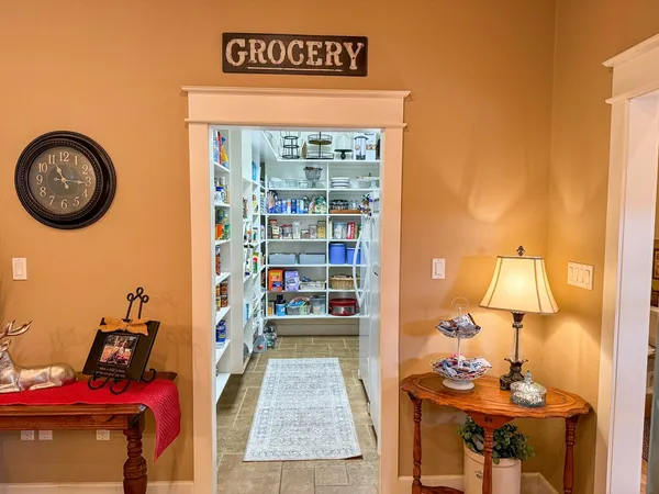 a view of a room that has a bed and a table in it