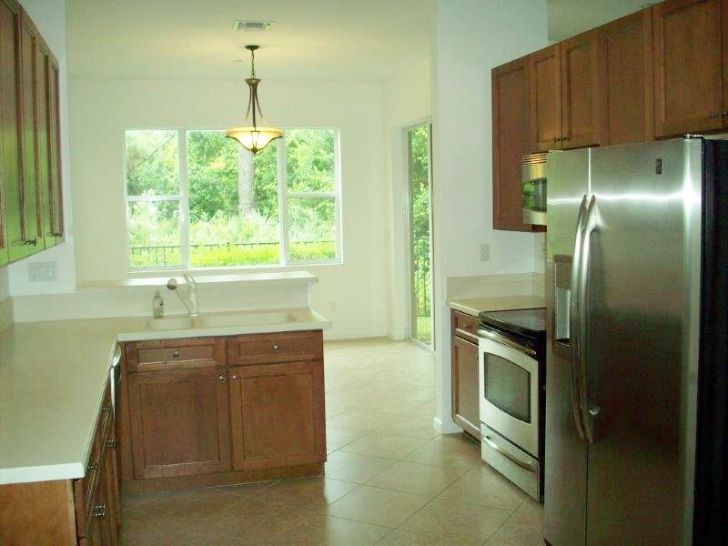 326 Southwest Walking Path Stuart, FL 34997 - Photo 10 of 49 a kitchen with kitchen island a counter top space a sink stainless steel appliances and cabinets