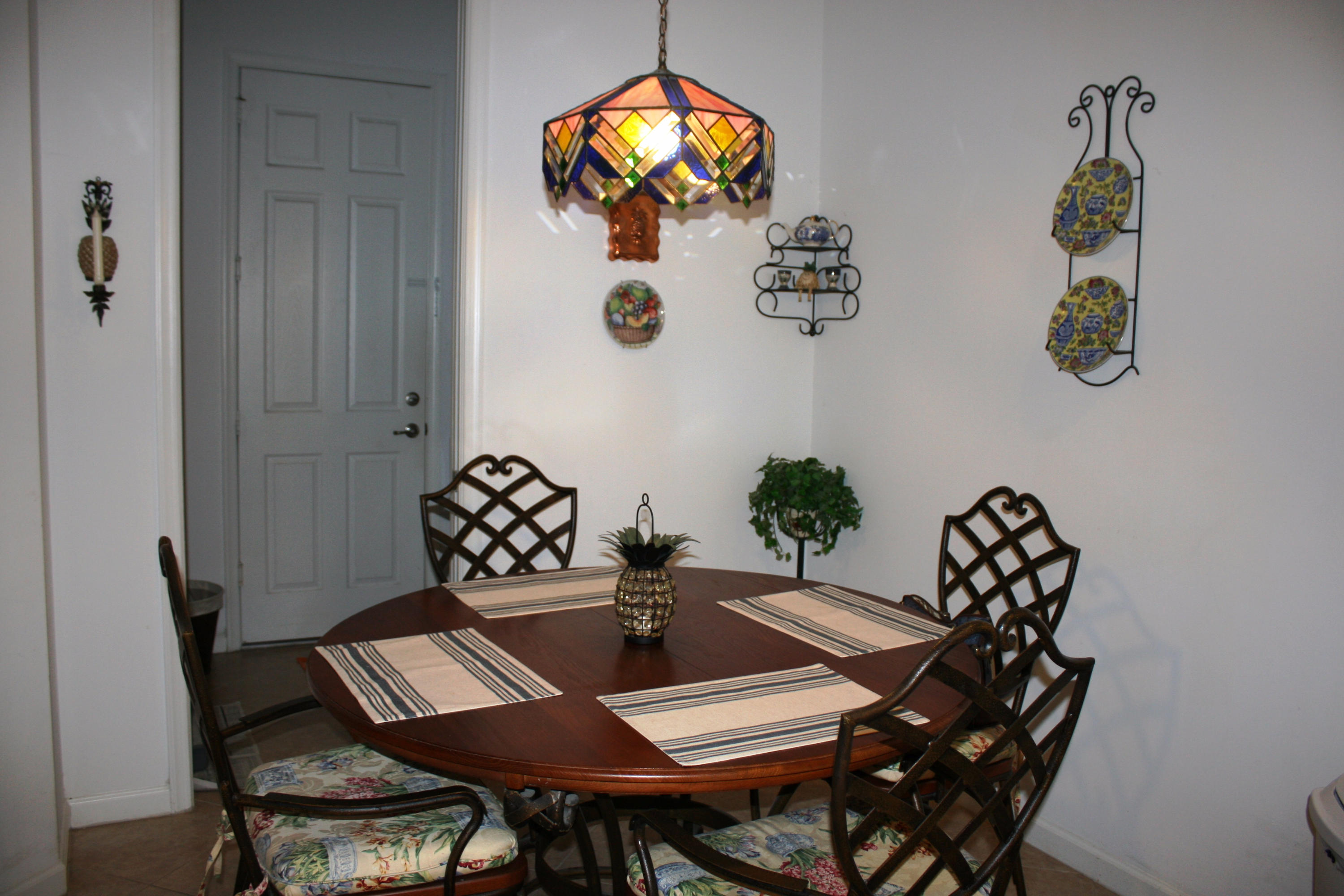 326 Southwest Walking Path Stuart, FL 34997 - Photo 12 of 49 a view of a dining room with furniture and chandelier