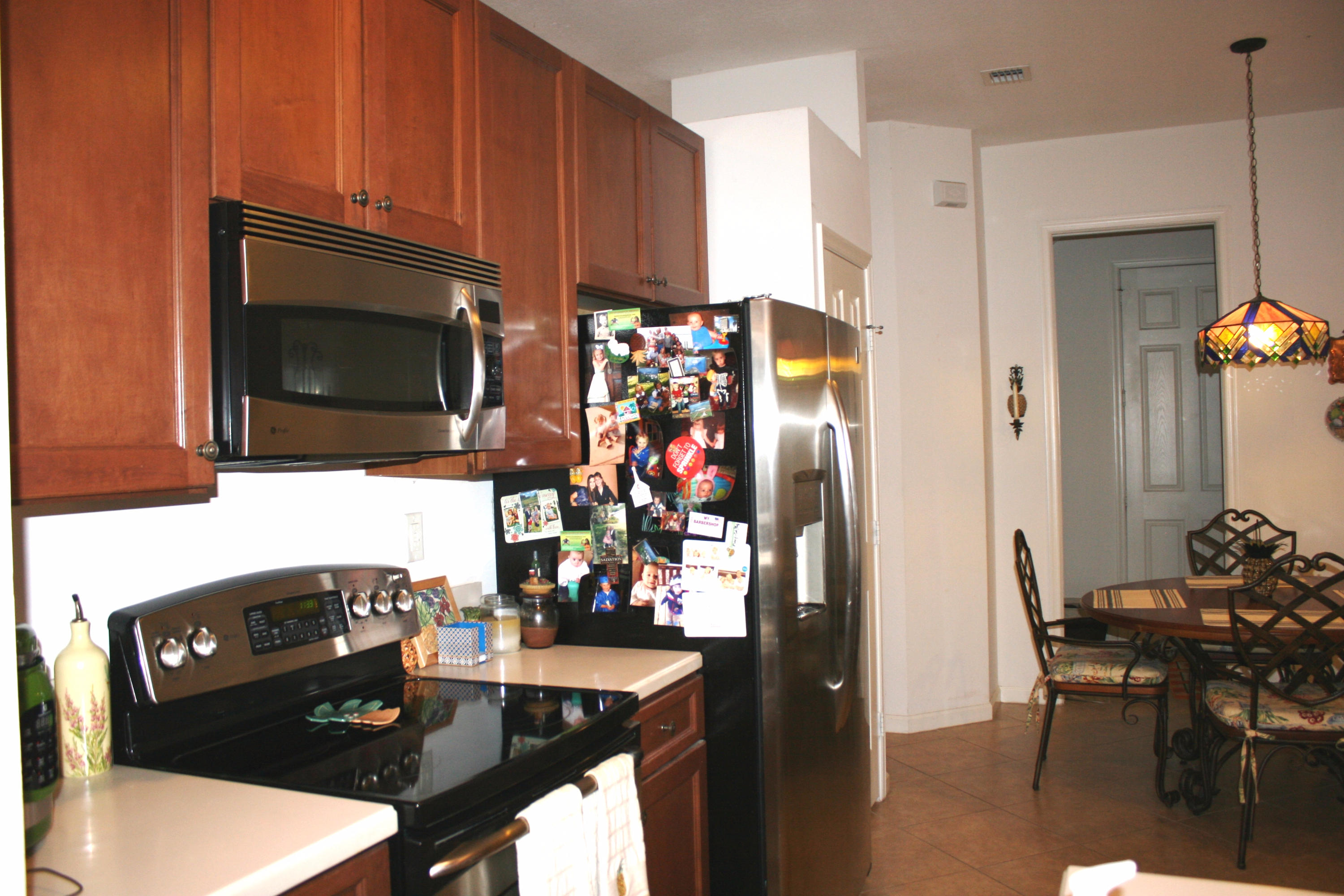 326 Southwest Walking Path Stuart, FL 34997 - Photo 14 of 49 a kitchen with stainless steel appliances a dining table and chairs