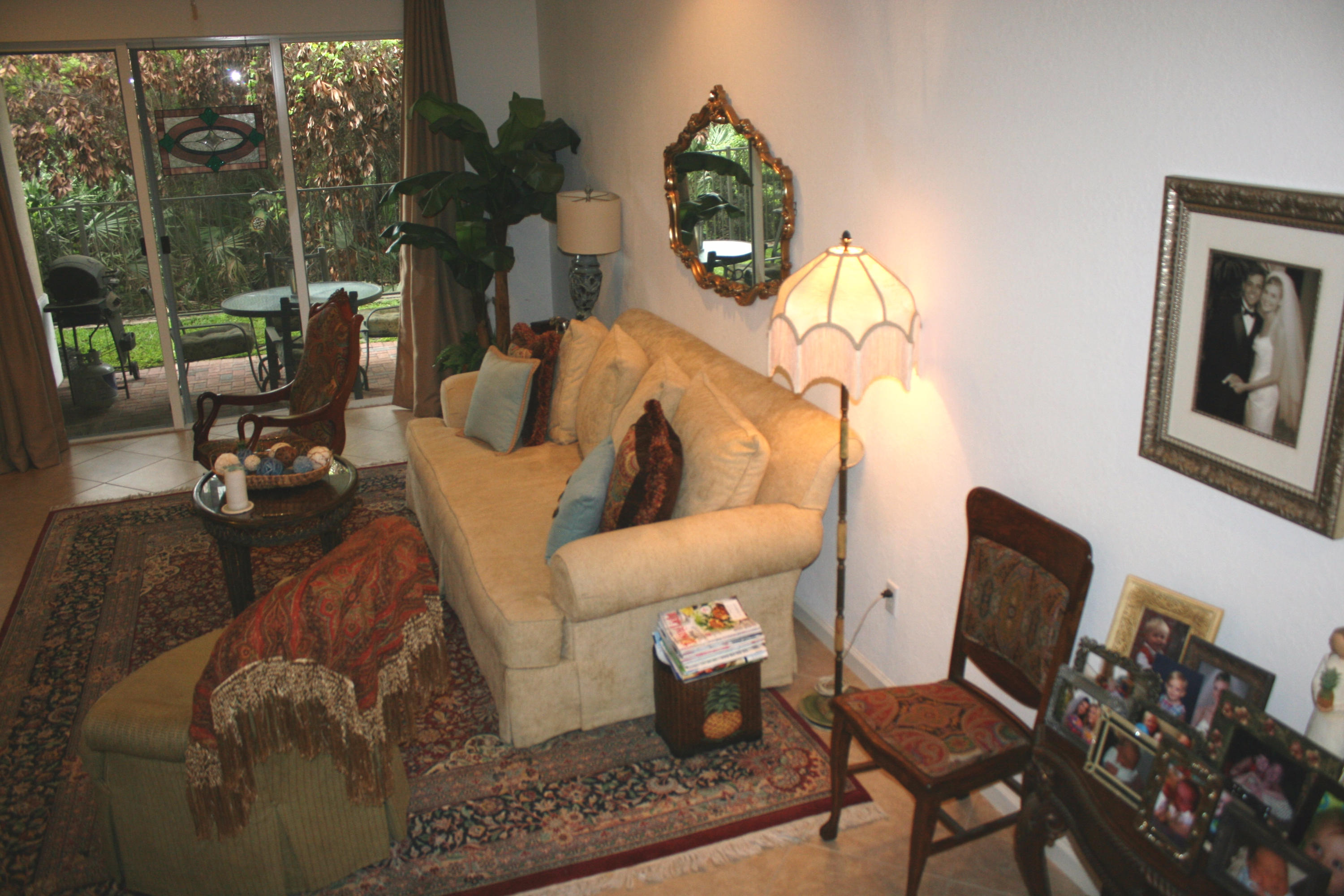 326 Southwest Walking Path Stuart, FL 34997 - Photo 2 of 49 a living room with furniture and a lamp