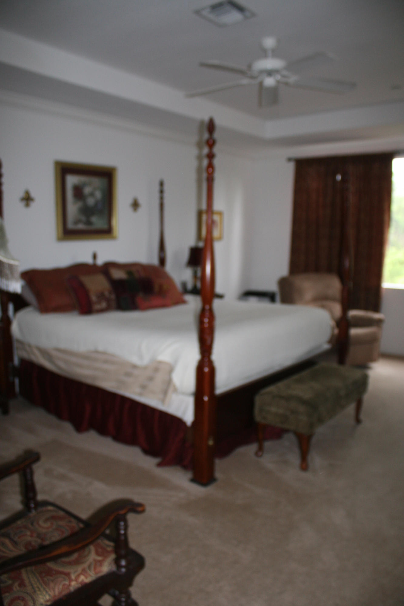 326 Southwest Walking Path Stuart, FL 34997 - Photo 25 of 49 a bedroom with a bed and lamp