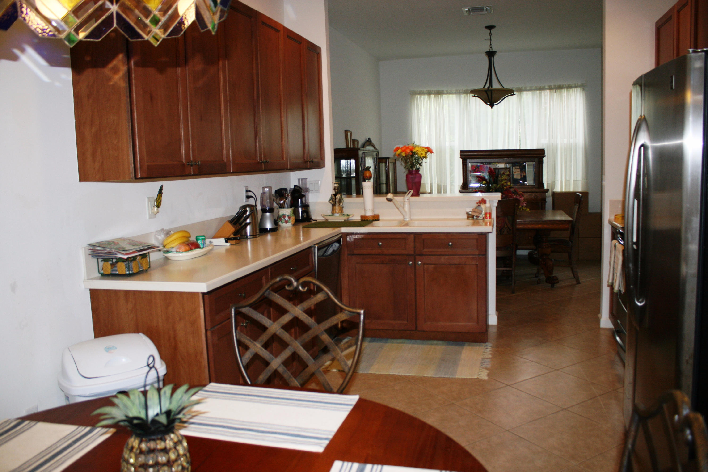 326 Southwest Walking Path Stuart, FL 34997 - Photo 9 of 49 a kitchen with stainless steel appliances a stove a sink a refrigerator and cabinets