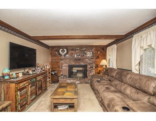 121 Chipaway Road Freetown, MA 02717 - Photo 24 of 37 a living room with furniture a flat screen tv and a fireplace