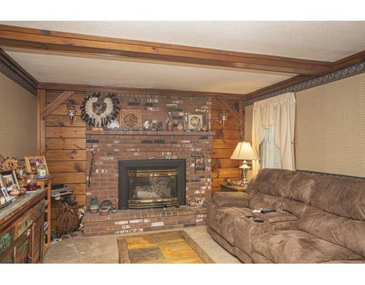121 Chipaway Road Freetown, MA 02717 - Photo 25 of 37 a living room with furniture a fireplace and a flat screen tv