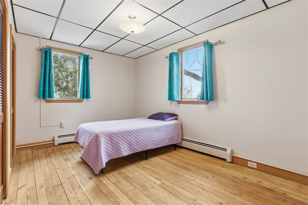 218 10th Street Aspinwall, PA 15215 - Photo 27 of 49 a bedroom with a bed and wooden floor
