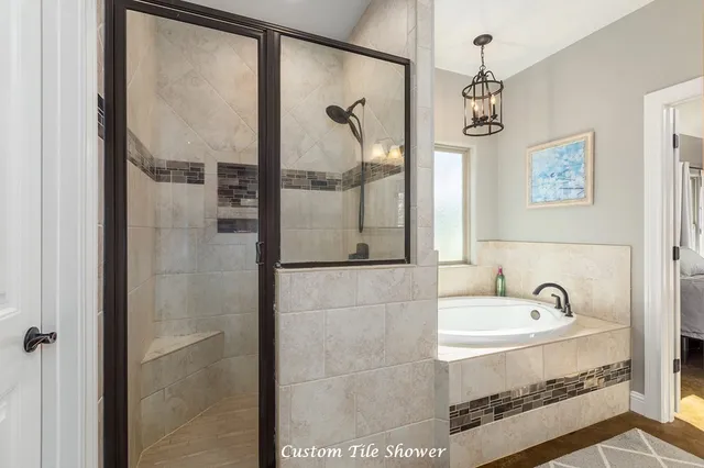 a bathroom with a granite countertop tub sink and a mirror