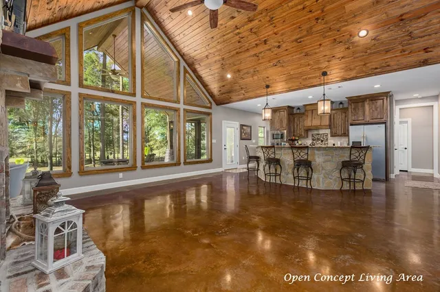 a dining hall with stainless steel appliances granite countertop a sink and cabinets