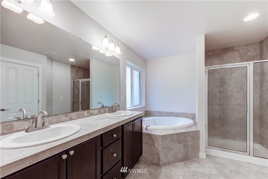 22330 35th Drive Southeast Bothell, WA 98021 - Photo 14 of 25 a bathroom with a double vanity sink mirror and shower