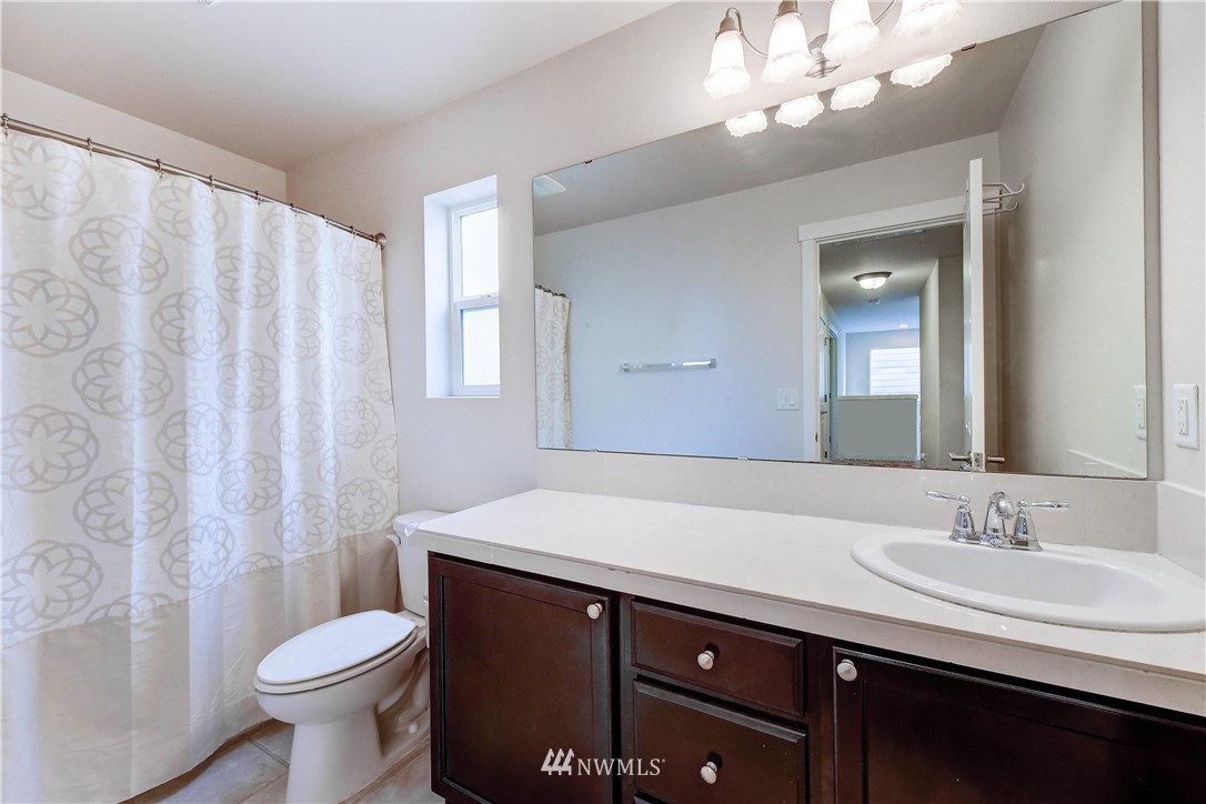 22330 35th Drive Southeast Bothell, WA 98021 - Photo 16 of 25 a bathroom with a sink vanity mirror and toilet