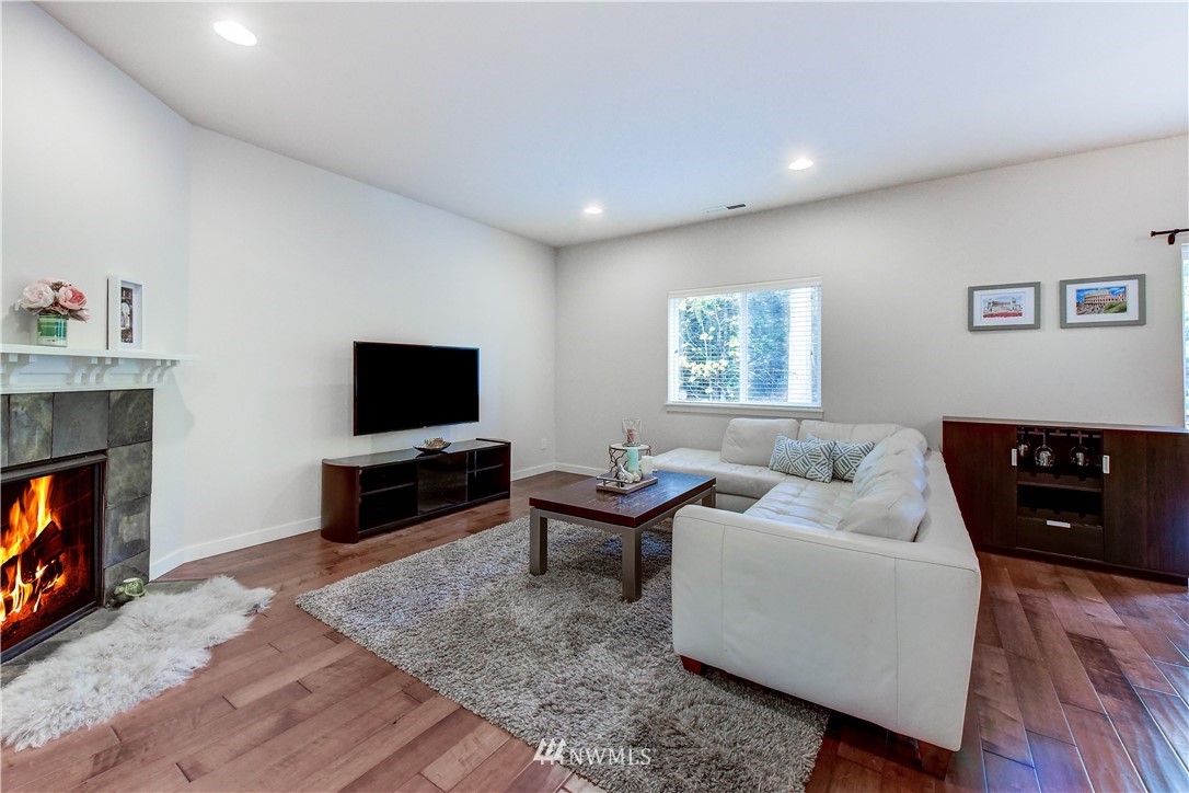 22330 35th Drive Southeast Bothell, WA 98021 - Photo 10 of 25 a living room with furniture a flat screen tv and a fireplace