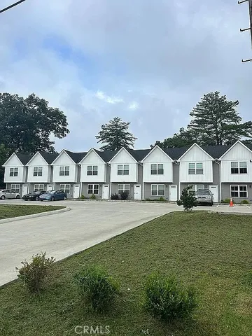 a front view of a residential houses with yard and green space