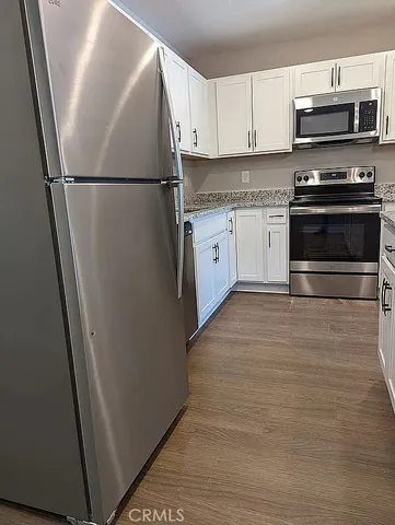 a white refrigerator freezer and a stove sitting inside of a kitchen