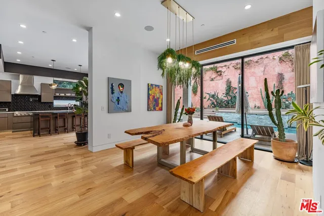 a living room with furniture a flat screen tv and a large window
