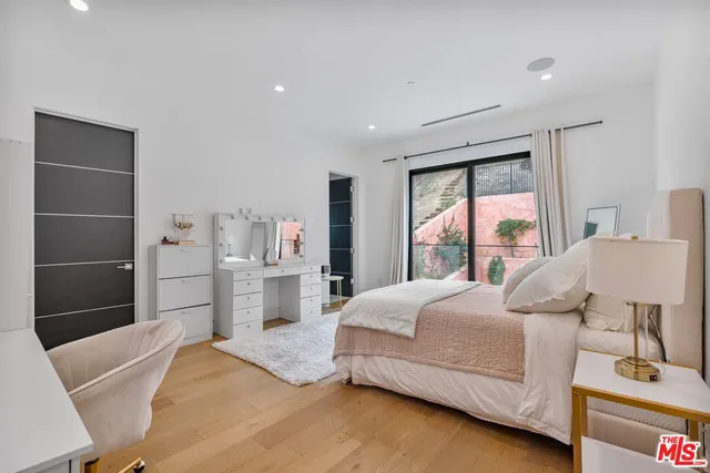 a bedroom with a bed and a large window