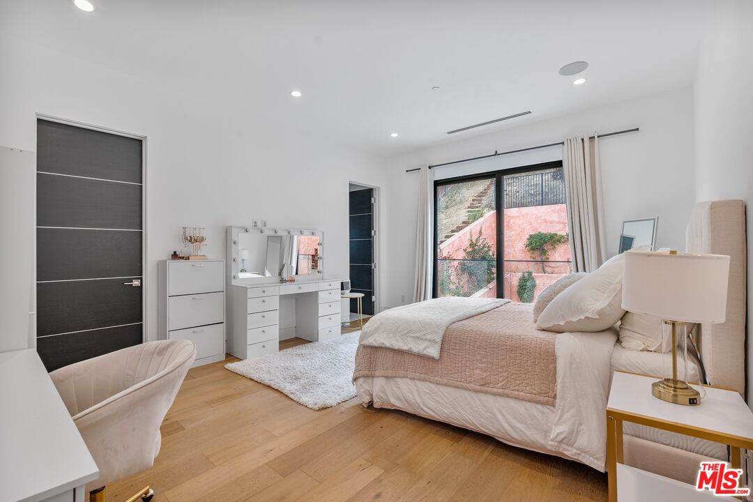 3553 Alana Drive Sherman Oaks, CA 91403 - Photo 16 of 35 a bedroom with a bed and a large window