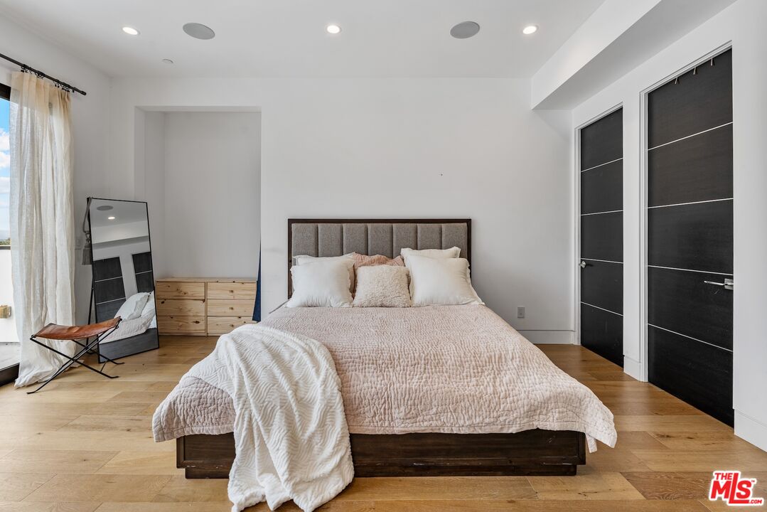 3553 Alana Drive Sherman Oaks, CA 91403 - Photo 18 of 35 a bedroom with a bed and wooden floor