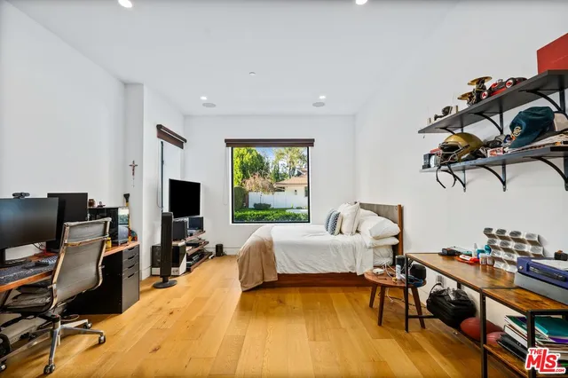 a bed room with a bed and a chair