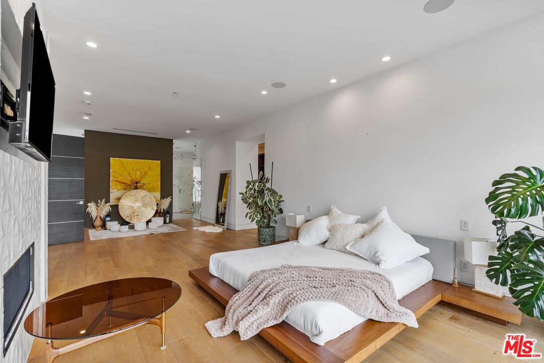 3553 Alana Drive Sherman Oaks, CA 91403 - Photo 23 of 35 a spacious bedroom with a large bed and a potted plant