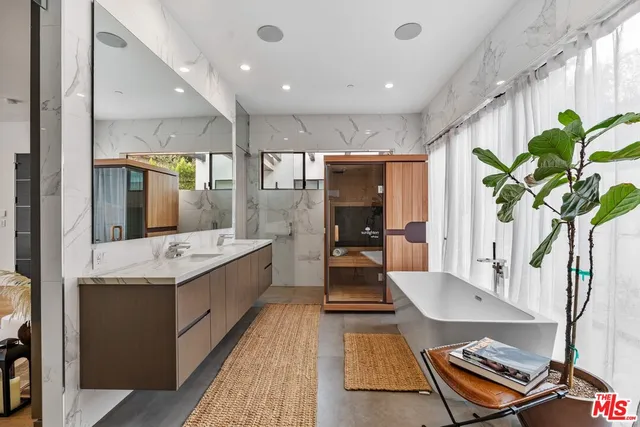 a large room with stainless steel appliances lots of counter space and wooden floor