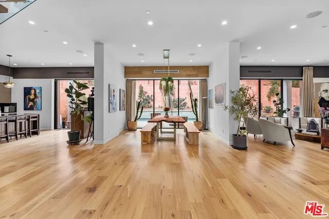 a living room with furniture and large windows
